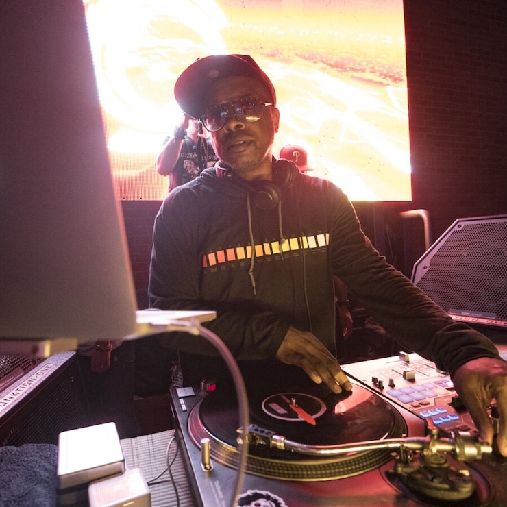 DJ Jazzy Jeff playing a DJ set, standing at turntables with a laptop