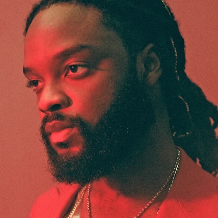 Press shot of Genesis Owusu with red light and red background