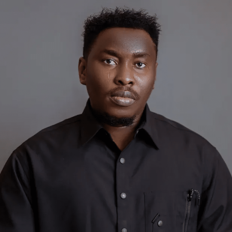 Press shot of Victor Thompson set against a grey background. Taken in 2023 by Nayaba Cosmos