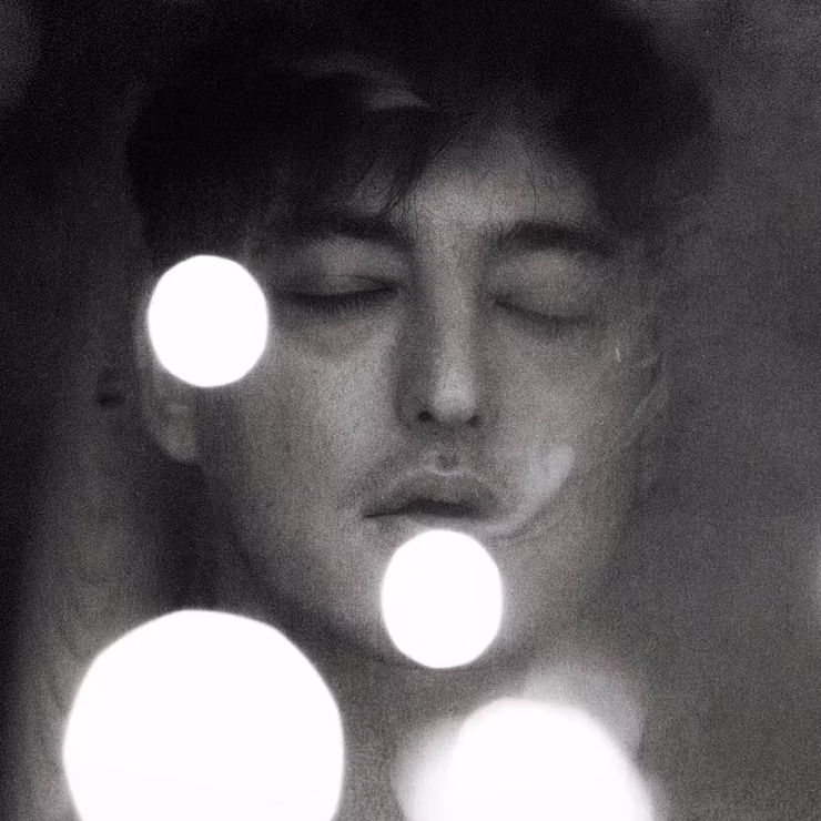 Press shot of JOJI with his eyes closed, black and white filter.